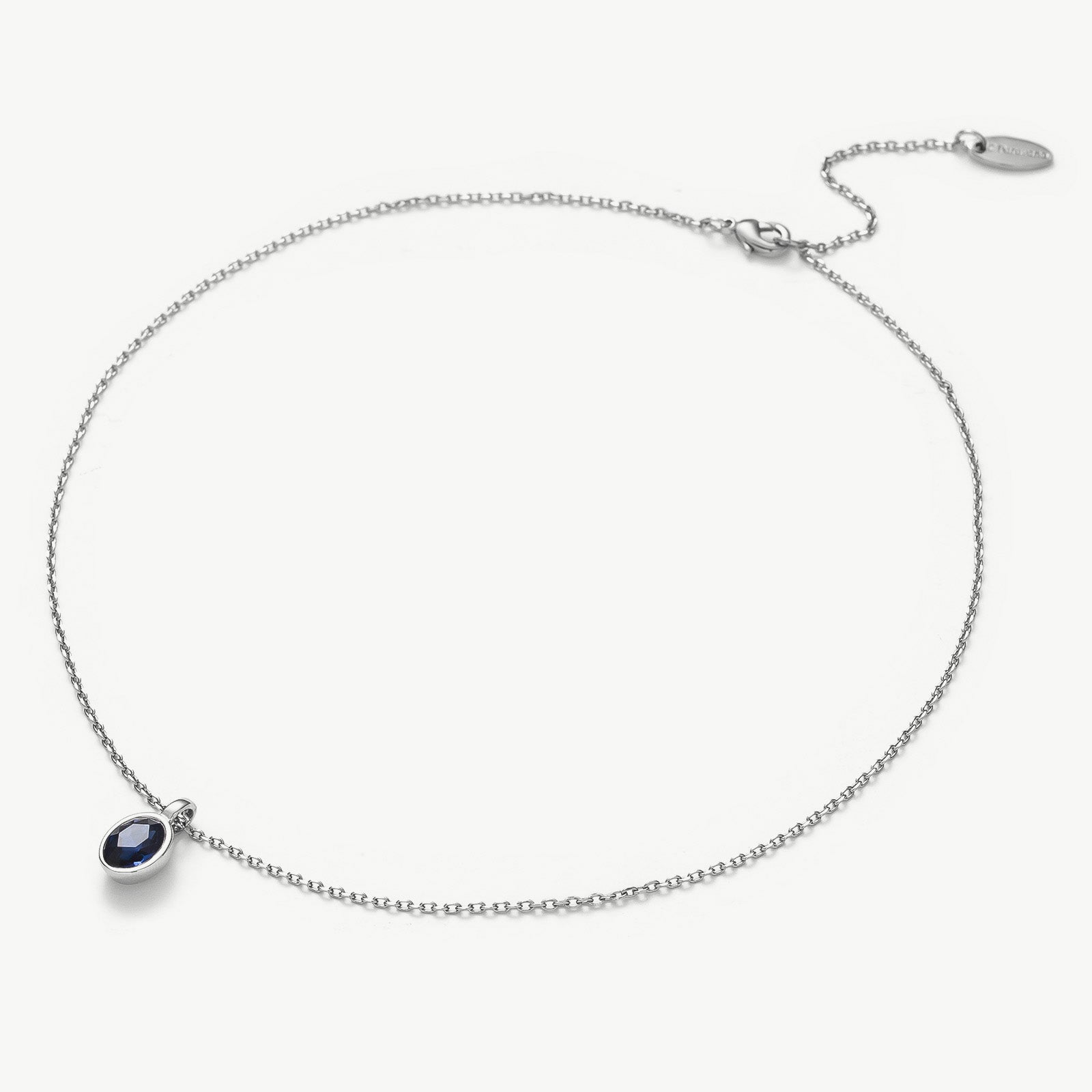 Agate Pendant Necklace in Sapphire, a deep sapphire charm captured in an agate pendant, creating a stylish and timeless accessory to add a pop of color to your ensemble.