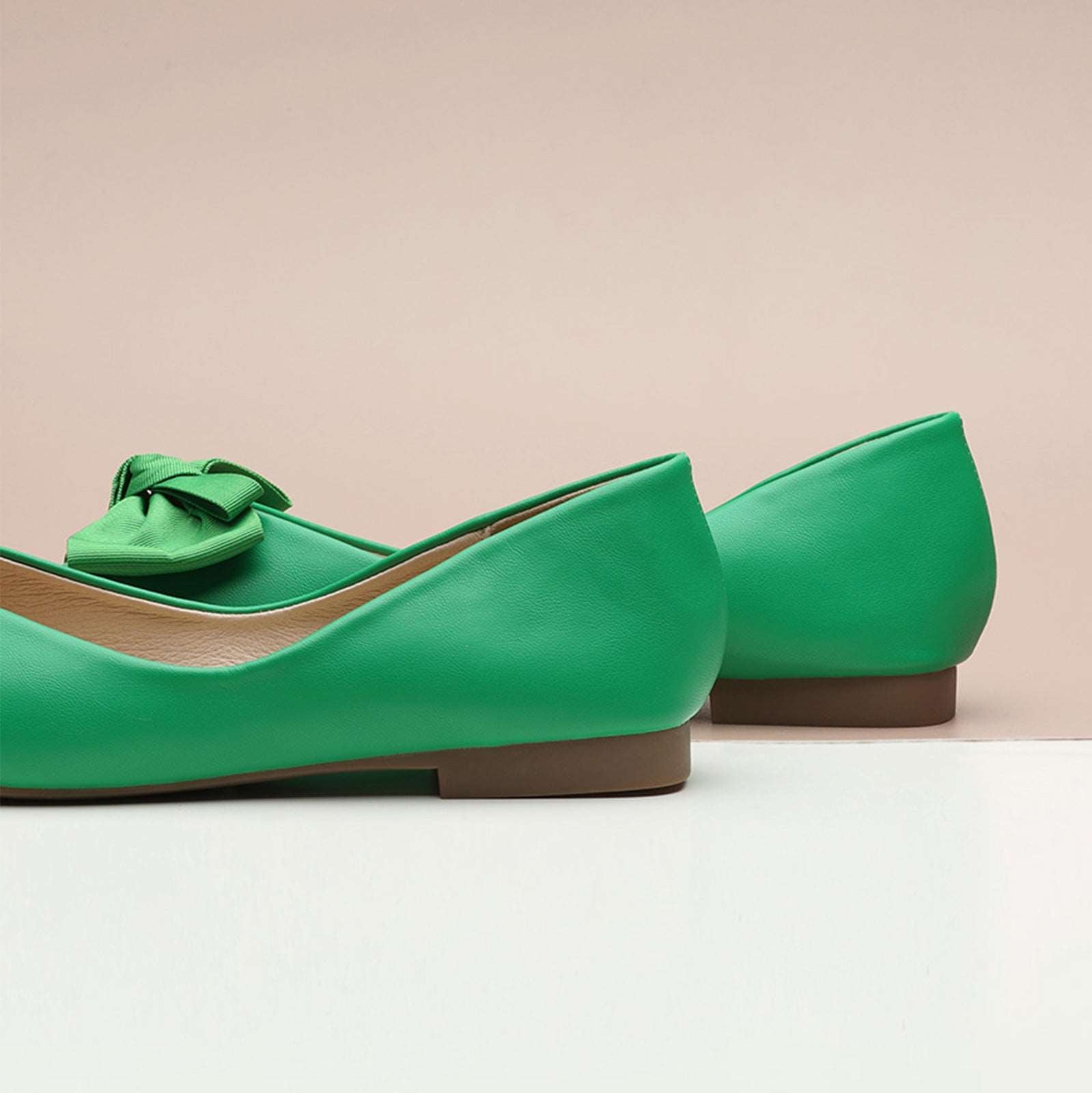 Stay on-trend with these fashion-forward square-toe flats in a trendy green shade, showcasing a playful bowknot detail and crafted from soft, supple leather for both style and comfort.