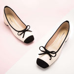 Crisp white low heels with a chic bowknot detail – timeless and versatile for various occasions