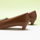 Brown Trapezoidal Buckle Low Heels, perfect for a confident and fashionable look in any urban setting.