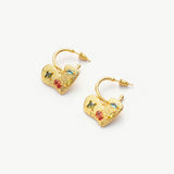 Hoop Earrings adorned with heart-shaped gemstone charms, a versatile and chic pair that effortlessly complements a range of outfits