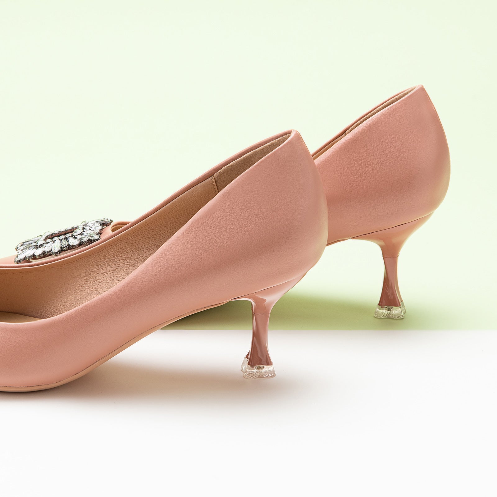 Step into sophistication with these pink pumps featuring crystal embellishments and a stylish buckle, perfect for a polished and refined look.