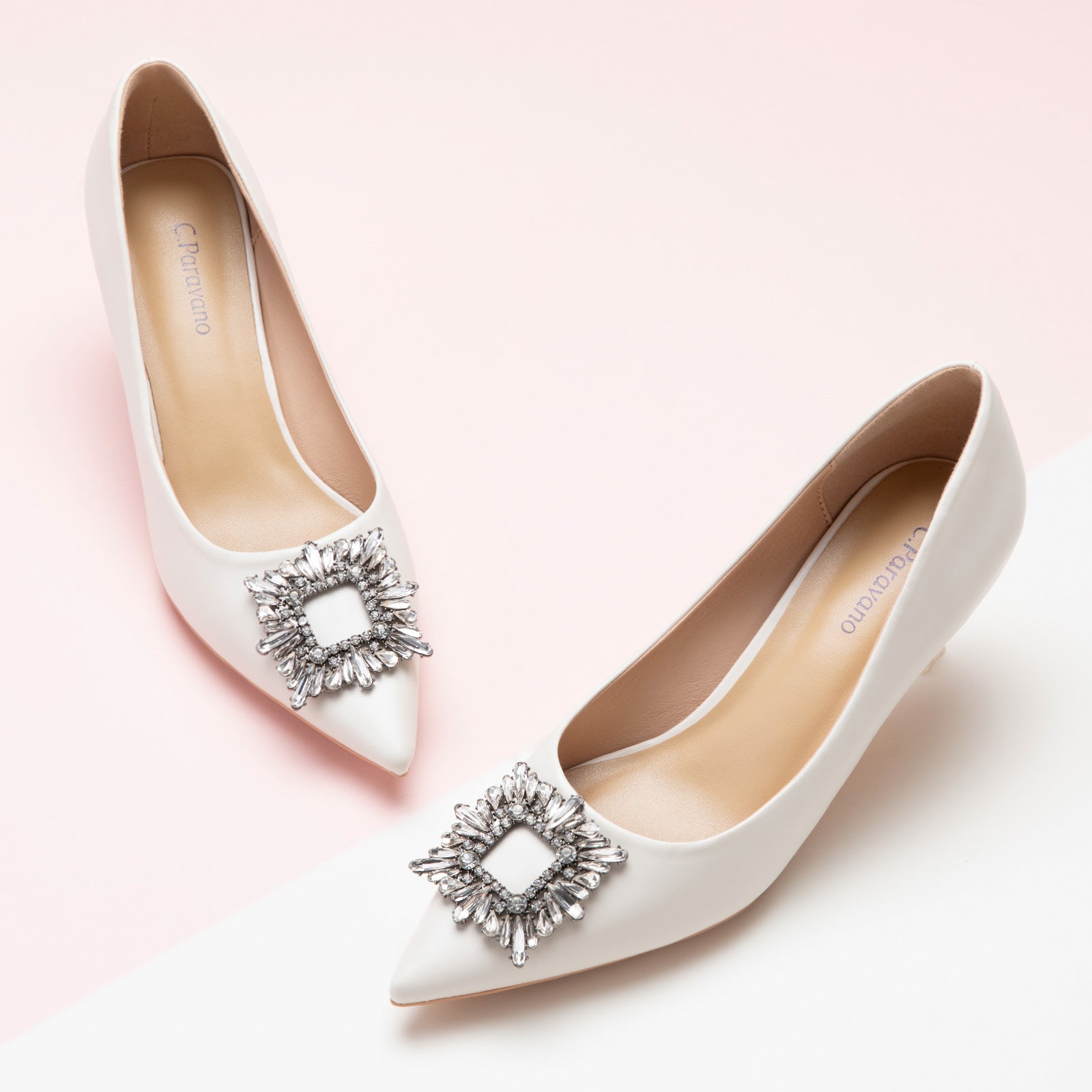 Crisp white pumps adorned with sparkling crystal embellishments and a stylish buckle – timeless and versatile for various occasions.