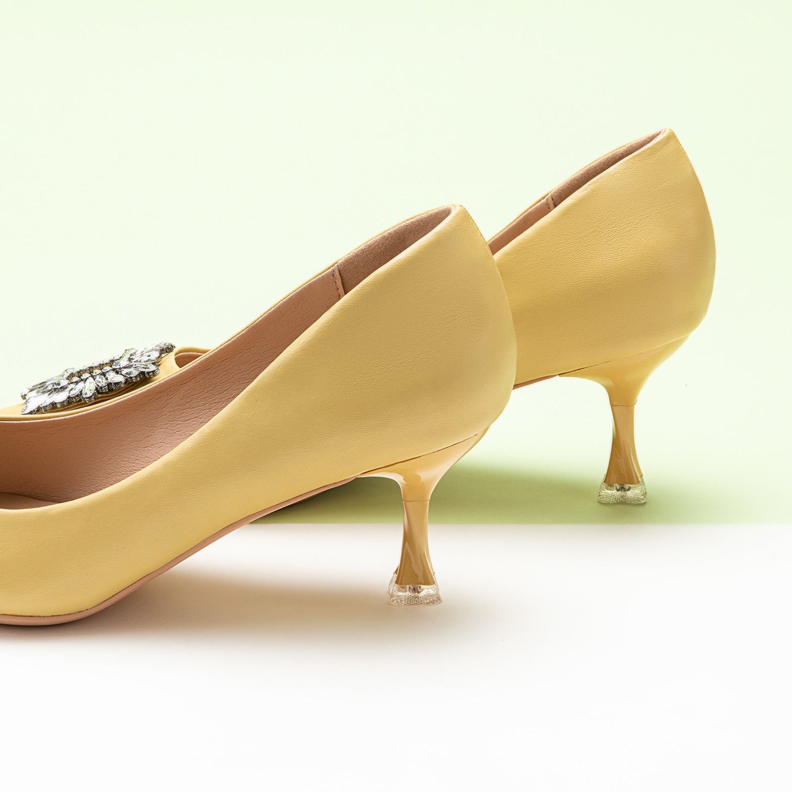 Embrace classic style with a twist of boldness with these yellow pumps, featuring sparkling crystal details and a delightful buckle for a statement look.