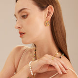 Crystal Wavy Stud Earrings in gold, a luxurious and elegant accessory that adds a touch of opulence to your ears