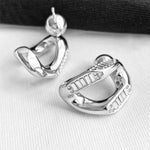 Crystal Wavy Stud Earrings in silver, a versatile and effortless pair that seamlessly complements your everyday or special occasion style