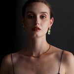 Gemstone Charm Hoop Earrings, versatile in design with various gemstone charms, these earrings offer an elegant and eye-catching accessory for any occasion