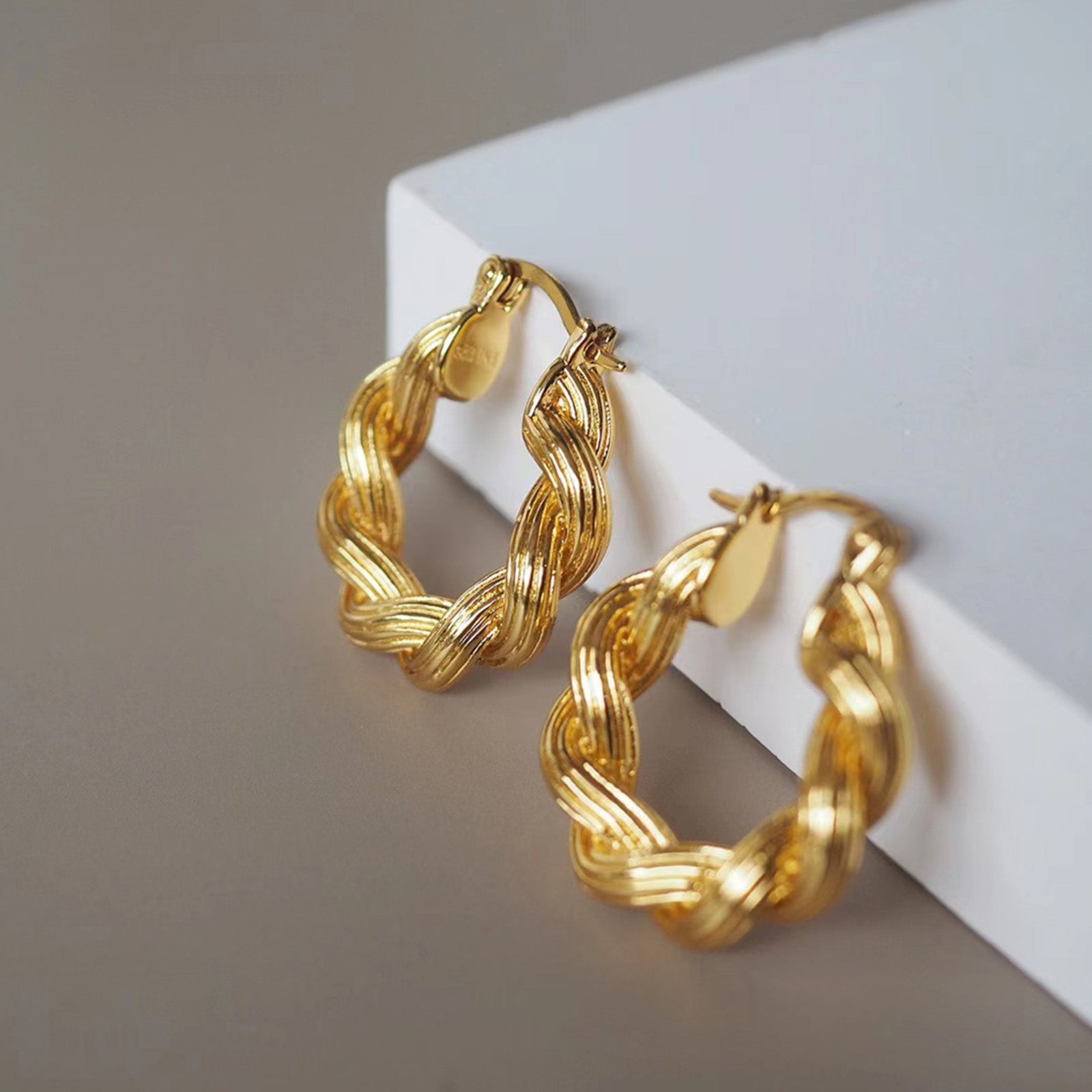 Double Rope Hoop Earrings making dynamic statements with their textured design, these hoops offer a stylish and eye-catching accessory for any occasion