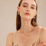 Crystal Twisted Earrings with sculpted details, these hoops provide an elegant and artistic charm, capturing attention with their unique and eye-catching crystal twists