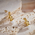 Pearl Drop Earrings in Silver, dynamically designed with silver circlets, these hoops offer a dynamic and eye-catching accessory for a bold and stylish appearance