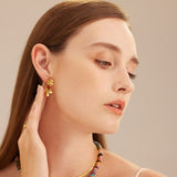 Hoop Earrings adorned with double flower charms, a stylish and elegant choice that adds a feminine and sophisticated flair to your look