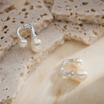 Silver Double Pearls Earrings, showcasing lustrous pearls in a silver setting, adding an elegant and timeless touch to your style