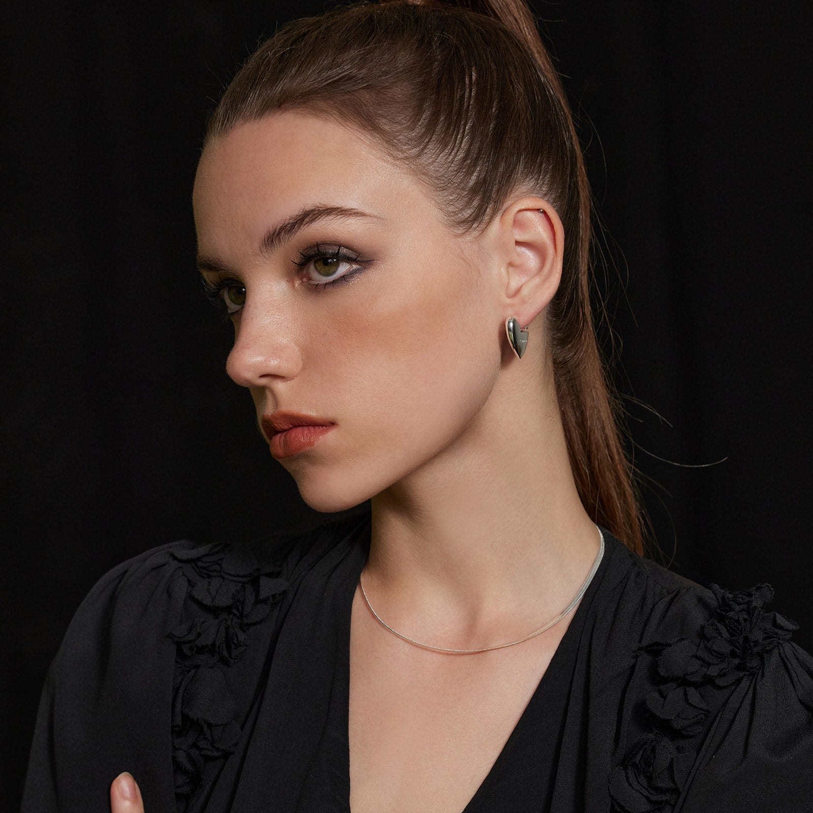 Silver Heart Hoop Earrings, a chic and embracing accessory with heart-shaped hoops, adding a stylish and timeless touch to your ensemble