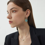 Heart Hoop Earrings in Blue Horizon, radiating with a horizon-inspired glow, these hoops add a touch of serenity with heart shapes in a calming blue hue