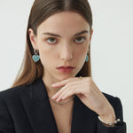 Shining Heart Hoop Earrings in Blue, reminiscent of the allure of the ocean, these hoops bring a touch of coastal charm to your ear ensemble with heart shapes