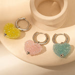 Heart Hoop Earrings in Cotton Candy Pink, exuding whimsical charm with heart-shaped hoops in a sweet and playful pink hue for a delightful appearance