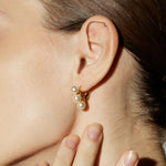 Gold Pearl Huggies, a timeless and classic choice that seamlessly blends the enduring beauty of pearls with the richness of a gold embrace