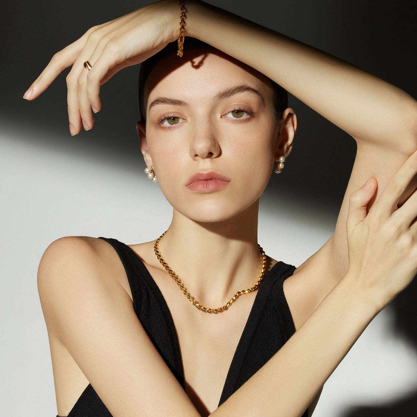 Pearl Huggie Earrings in Gold, radiating with the lustrous radiance of pearls set against a golden backdrop, a perfect blend of sophistication and grace.