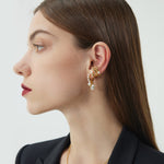 Gold Pearl Huggie Hoops, featuring a lustrous display of pearls against a golden backdrop, adding a touch of opulence and sophistication to your ear ensemble