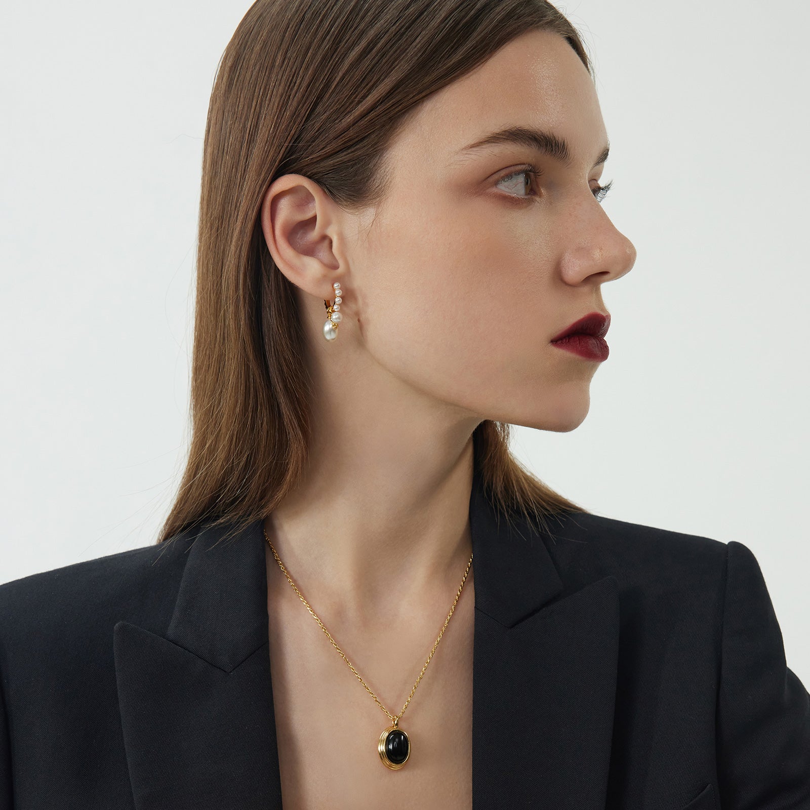 Pearl Huggie Hoops in a sun-kissed gold hue, showcasing pearls that are delicately adorned to bring a radiant and sunlit glow to your ears.