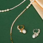 Silver Pearl Huggie Hoops creating an elegant circlet of pearls, blending the sleekness of silver with the timeless beauty of pearls for a refined and stylish look