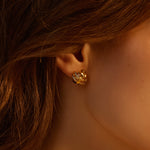 Intricately designed Coiled Stud Earrings adorned with pearls, adding a touch of modern charm to your ears
