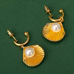 Pearl Shell Hoops, radiating nautical allure with a fusion of pearls and shell motifs, these earrings add a touch of sophistication and glamour, perfect for a seaside-inspired look