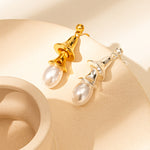 Pearl Drop Earrings in Silver, radiating with the radiant allure of pearls and silver, these earrings add a touch of sophistication and glamour to your overall look