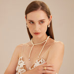 Long Pearl Necklace, a classic cascade of pearls that gracefully falls along your neckline, creating a versatile and refined accessory suitable for both formal events and everyday wear