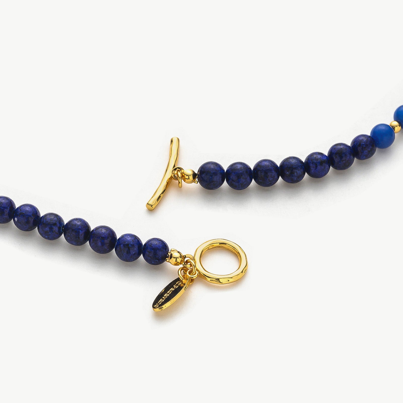  Lapis Blue Necklace, a lustrous lapis charm captured in a delicate chain, creating a stylish and timeless accessory that reflects the beauty of the night sky