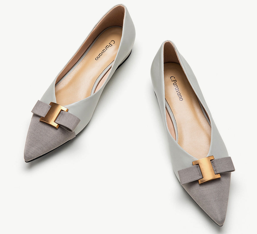 Grey leather flats adorned with stylish embellishments for a touch of sophistication