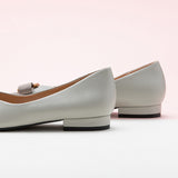 Classic grey leather flats featuring decorative details