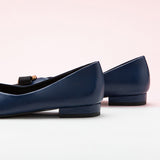 Classic navy leather flats featuring decorative details