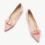 Pink leather flats adorned with stylish embellishments for a touch of elegance