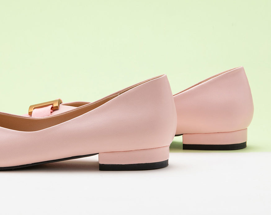 Classic pink leather flats featuring decorative details