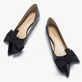Elegant black Bow-Embellished Off-Center Flats, a stylish and charming choice.