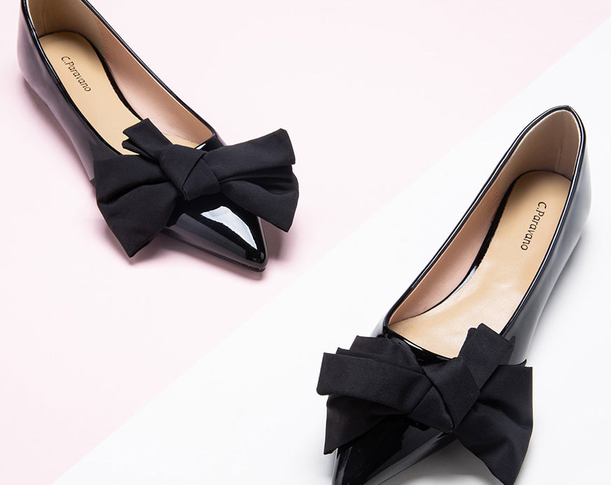 Chic black Off-Center Flats adorned with a delicate bow, exuding sophistication