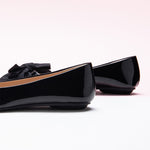 Fashionable black Bow-Embellished Flats with an off-center design, a unique and trendy look.