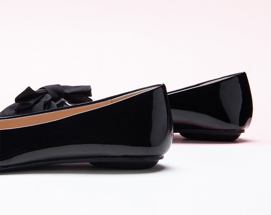 Fashionable black Bow-Embellished Flats with an off-center design, a unique and trendy look.