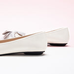 Fashionable ivory Bow-Embellished Flats with an off-center design, a trendy and unique look.