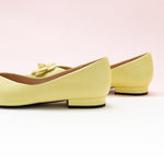 Elegant Yellow Leather Flats with Camellia Embellishment.