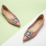 Step into sophistication with these pink flats featuring a crystal buckle, perfect for a polished and refined look.