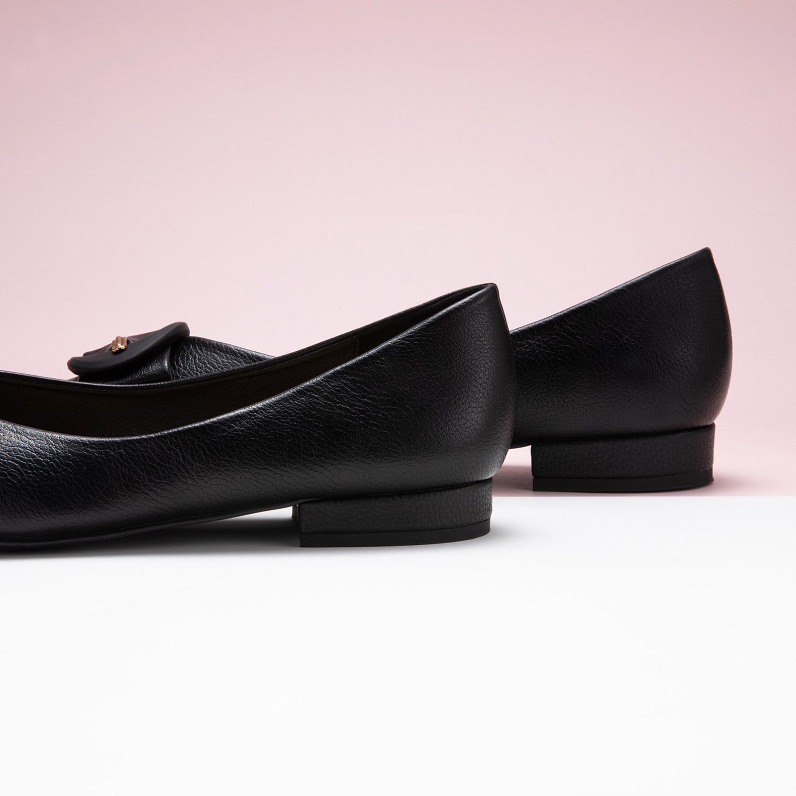 Black Grain Leather Flats with a pointed toe, providing a chic and polished look.