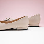 Grain Leather Point Toe Flats in White, providing a clean and contemporary touch to your ensemble