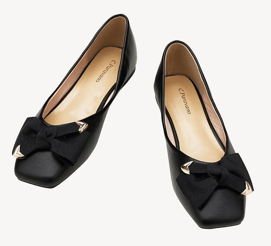 Black square-toed flats with a stylish metal bowknot detail.