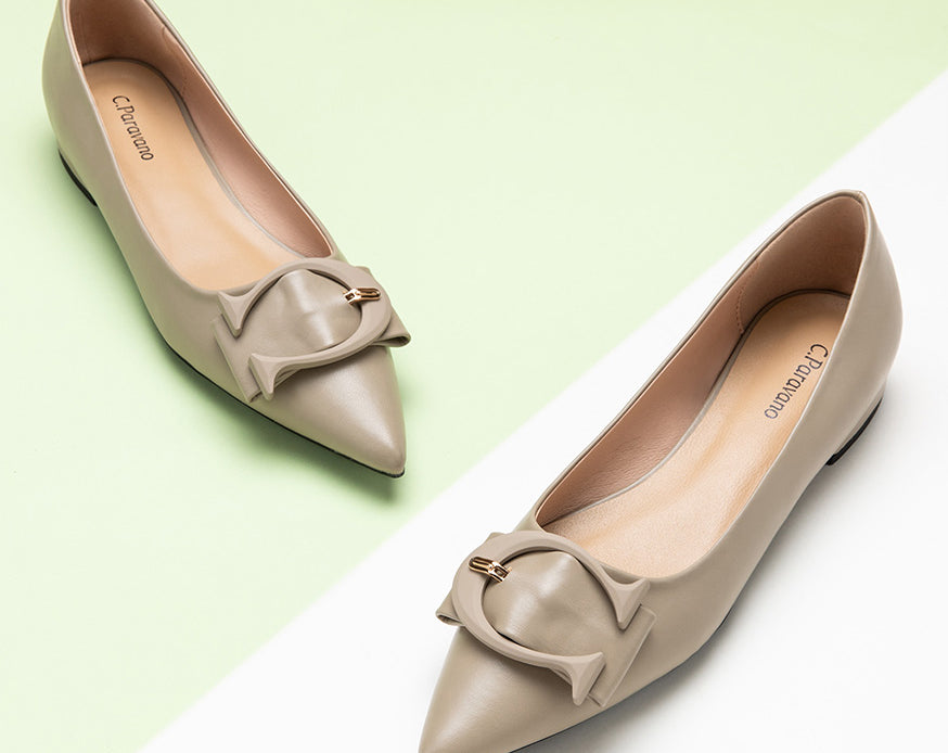 Pair of stylish pointed toe flats in a rich Camel hue with prominent buckles