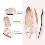 Step into sophistication with these white flats featuring a pointed toe and a chic C buckle, perfect for a polished and refined look.