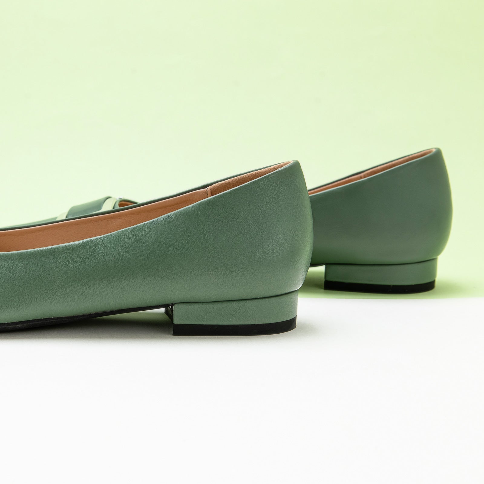 Green Flats with a stylish Metal Buckle and Pointed Toe, perfect for a confident and fashionable look in any urban setting.