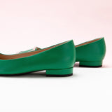 Green Trapezoidal Buckle Flats, perfect for a confident and fashionable look in any urban setting