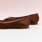 Brown Ballet Flats with a silky bowknot, perfect for a confident and fashionable look in any urban setting